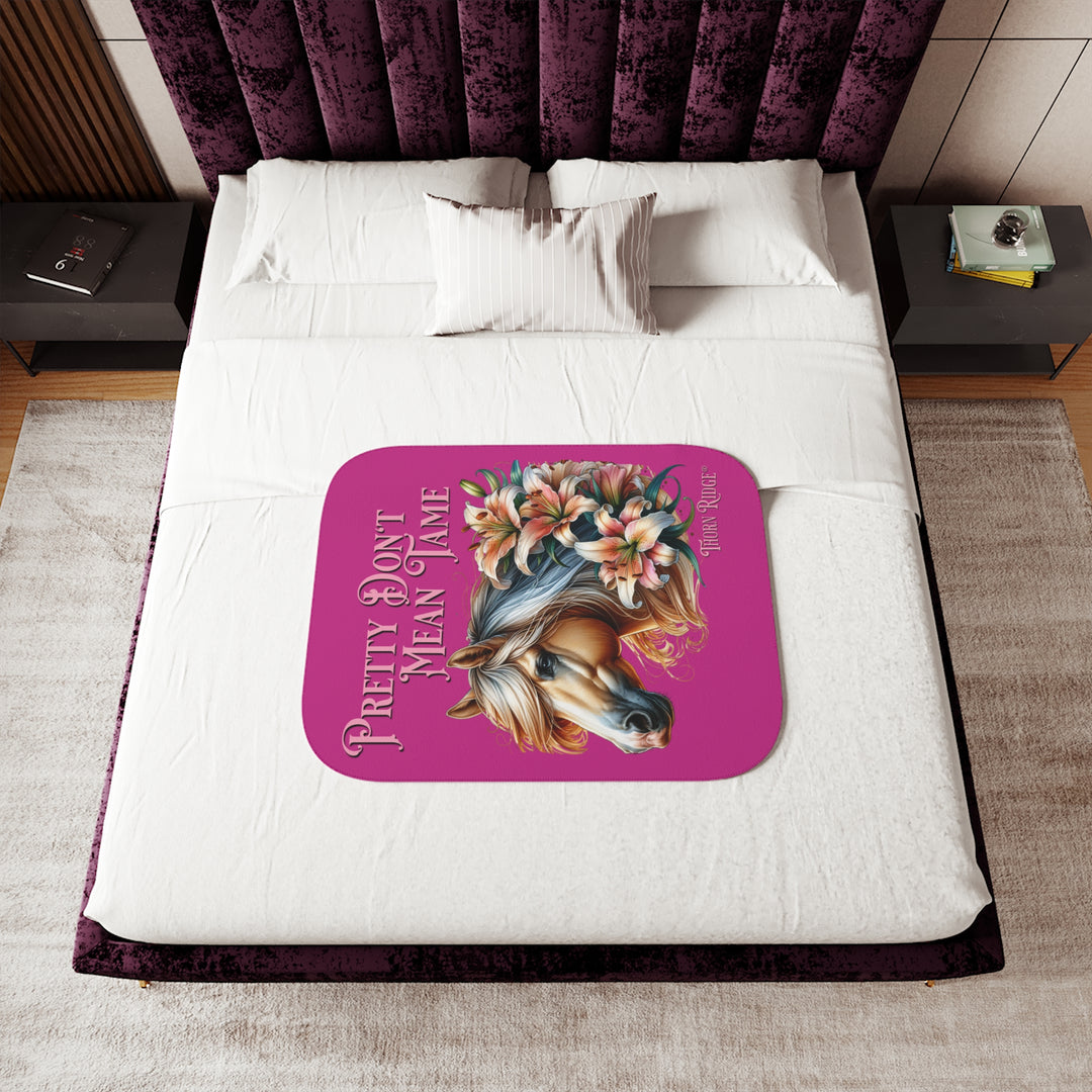 Pretty Don't Mean Tame hot pink sherpa blanket with an illustration of a palomino horse and flowers by Thorn Ridge®