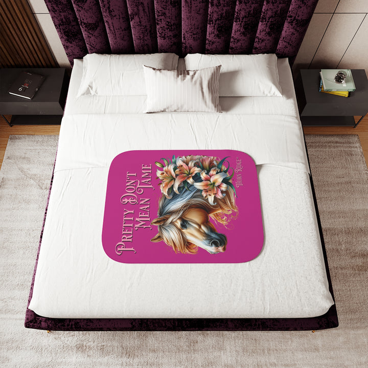 Pretty Don't Mean Tame hot pink sherpa blanket with an illustration of a palomino horse and flowers by Thorn Ridge®