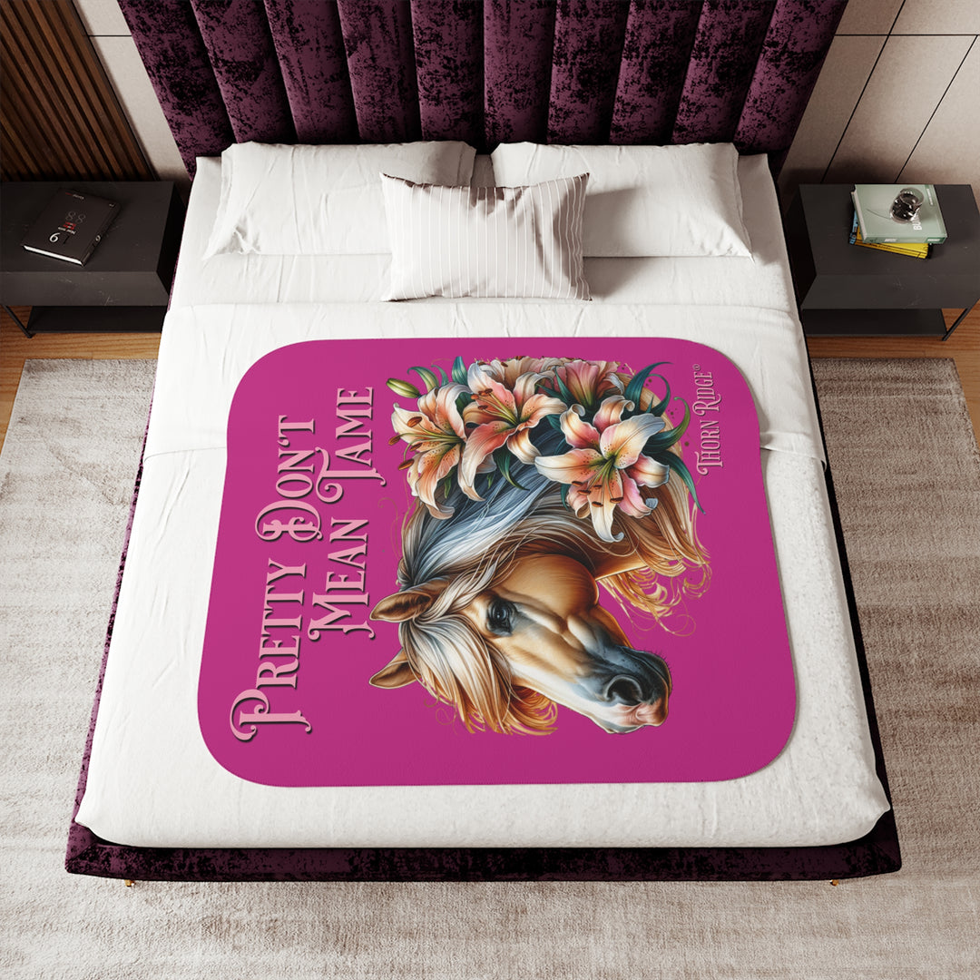 Pretty Don't Mean Tame hot pink sherpa blanket with an illustration of a palomino horse and flowers by Thorn Ridge®