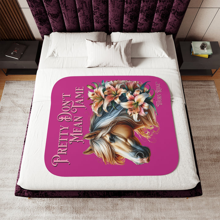 Pretty Don't Mean Tame hot pink sherpa blanket with an illustration of a palomino horse and flowers by Thorn Ridge®