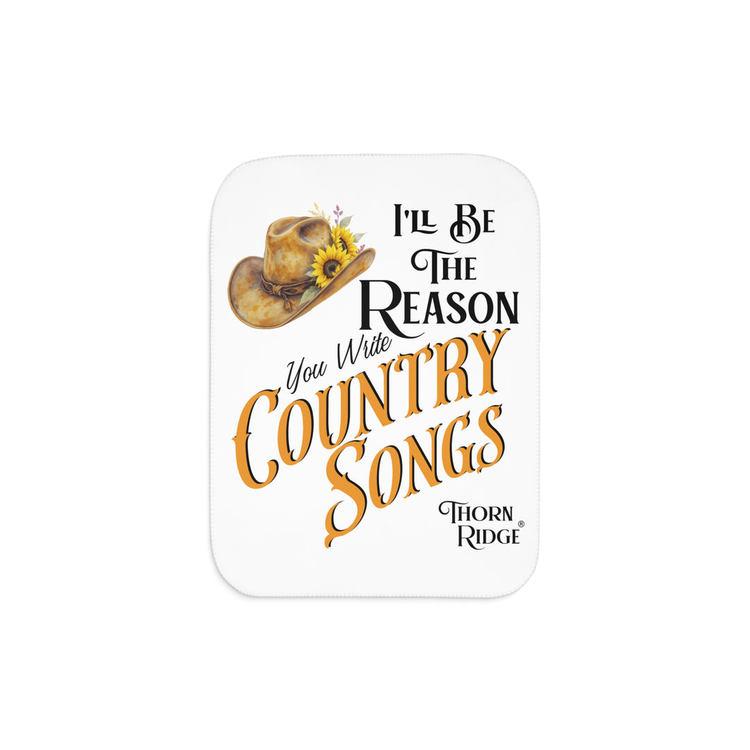 Decorative white sherpa blanket with a yellow sunflower cowgirl hat, sunflower, and text 'I'll be the reason you write country songs' by Thorn Ridge®
