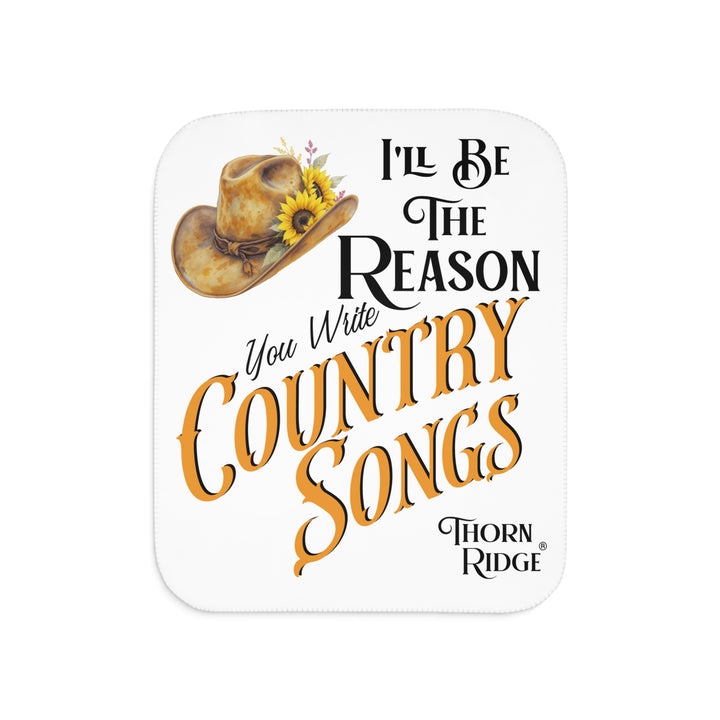 Decorative white sherpa blanket with a yellow sunflower cowgirl hat, sunflower, and text 'I'll be the reason you write country songs' by Thorn Ridge®