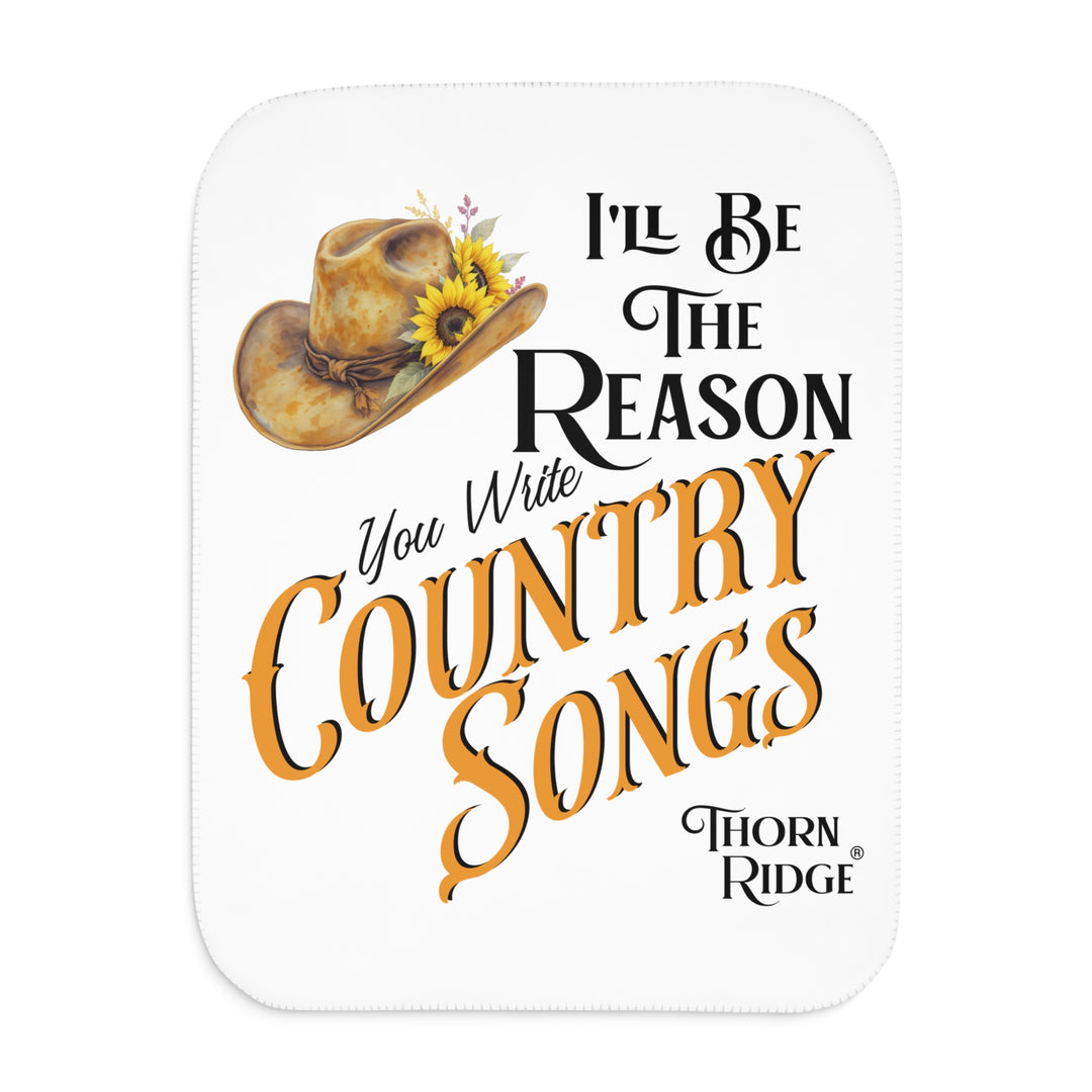 Decorative white sherpa blanket with a yellow sunflower cowgirl hat, sunflower, and text 'I'll be the reason you write country songs' by Thorn Ridge®