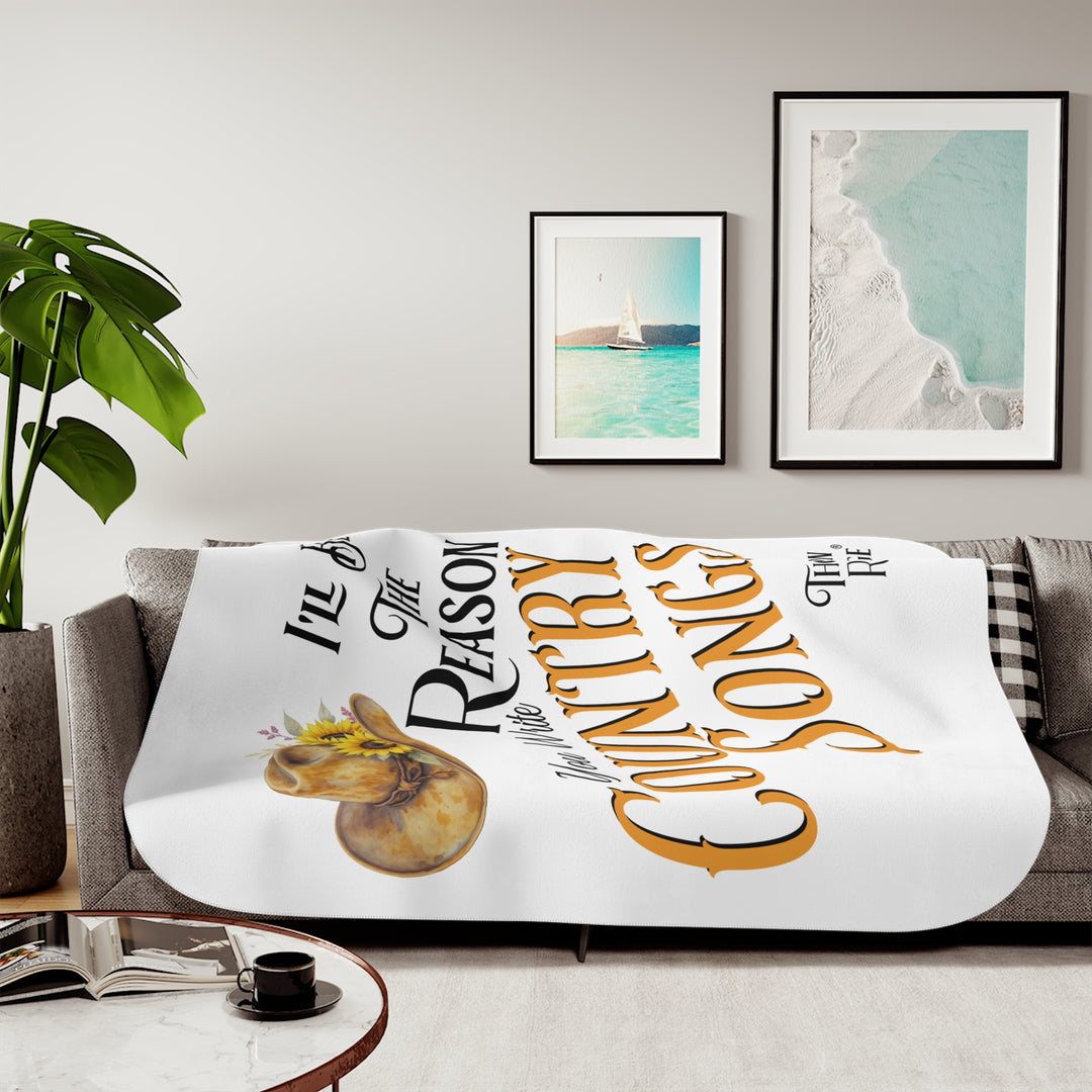 Decorative white sherpa blanket with a yellow sunflower cowgirl hat, sunflower, and text 'I'll be the reason you write country songs' by Thorn Ridge®
