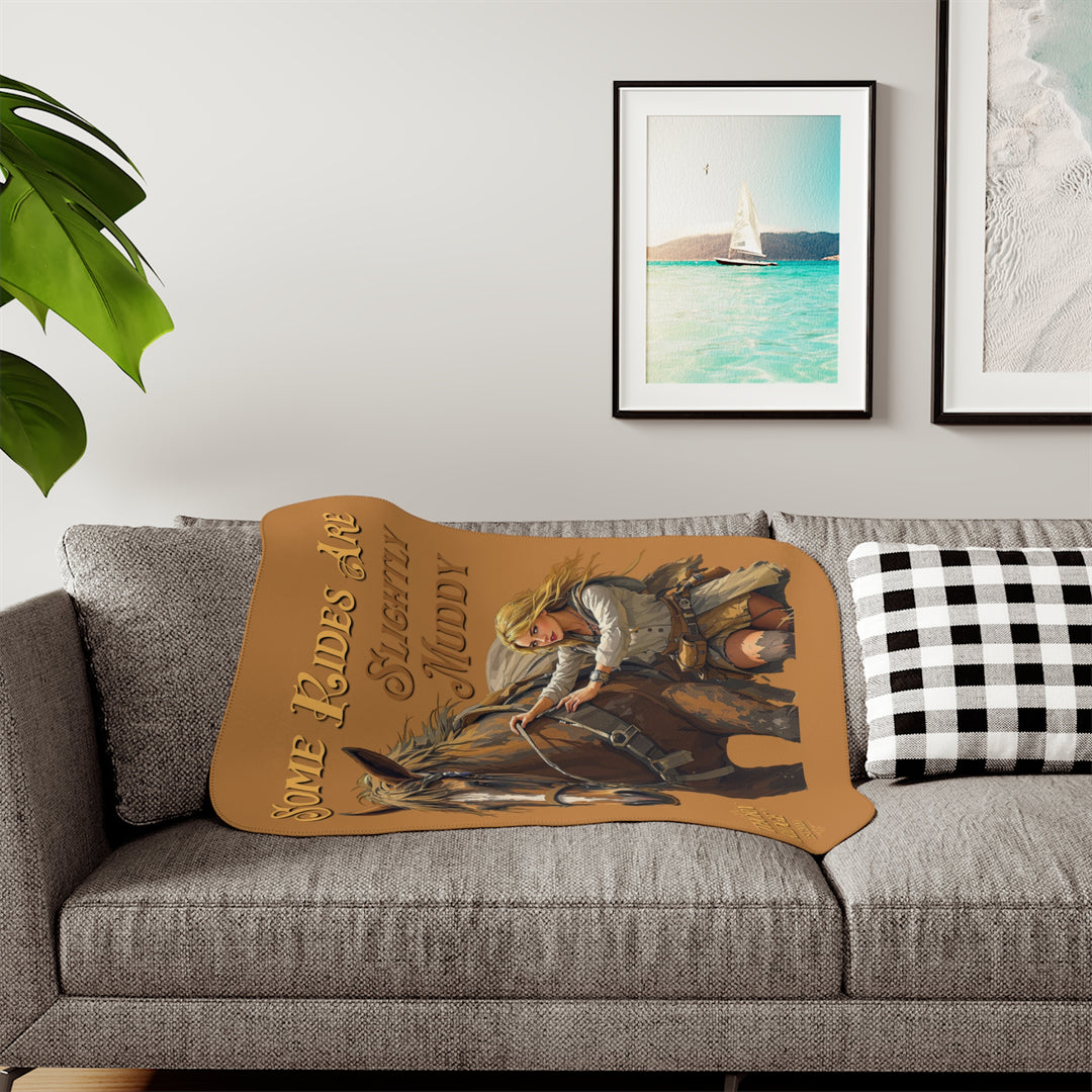 Some Rides Are Slightly Muddy tan sherpa blanket with an illustration of a draft horse in tack and a blond woman walking beside it both covered in mud and branded Thorn Ridge® EST 2020.