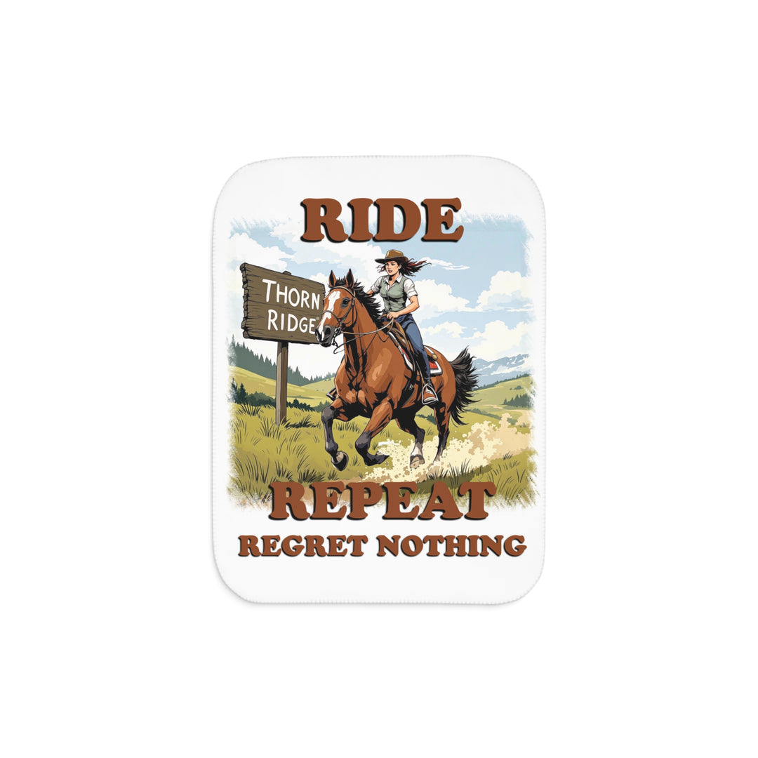 Decorative white sherpa blanket with a horse and rider graphic and text 'Ride Repeat Regret Nothing' and a sign that says the brand name Thorn Ridge®.