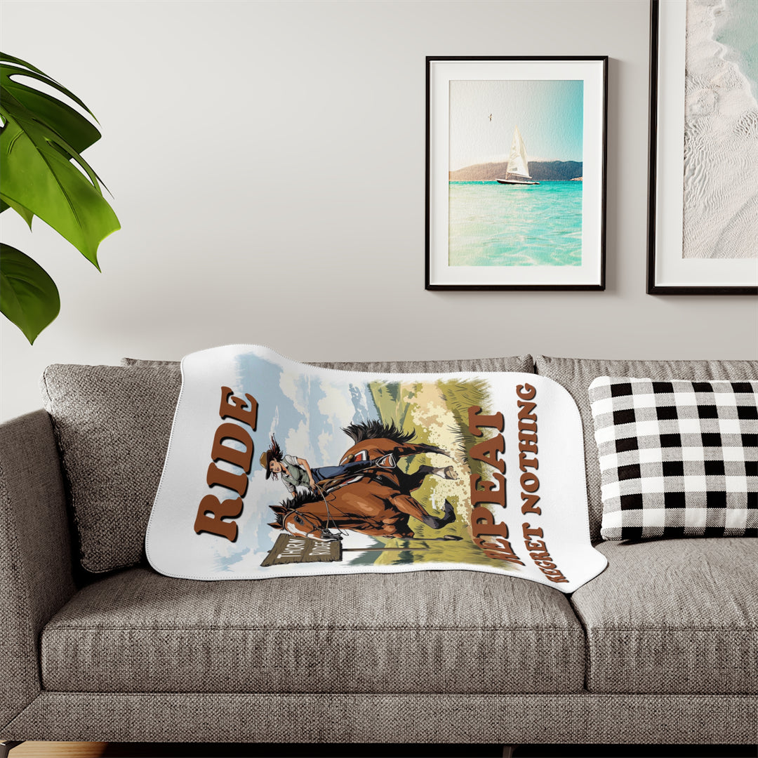 Decorative white sherpa blanket with a horse and rider graphic and text 'Ride Repeat Regret Nothing' and a sign that says the brand name Thorn Ridge®.