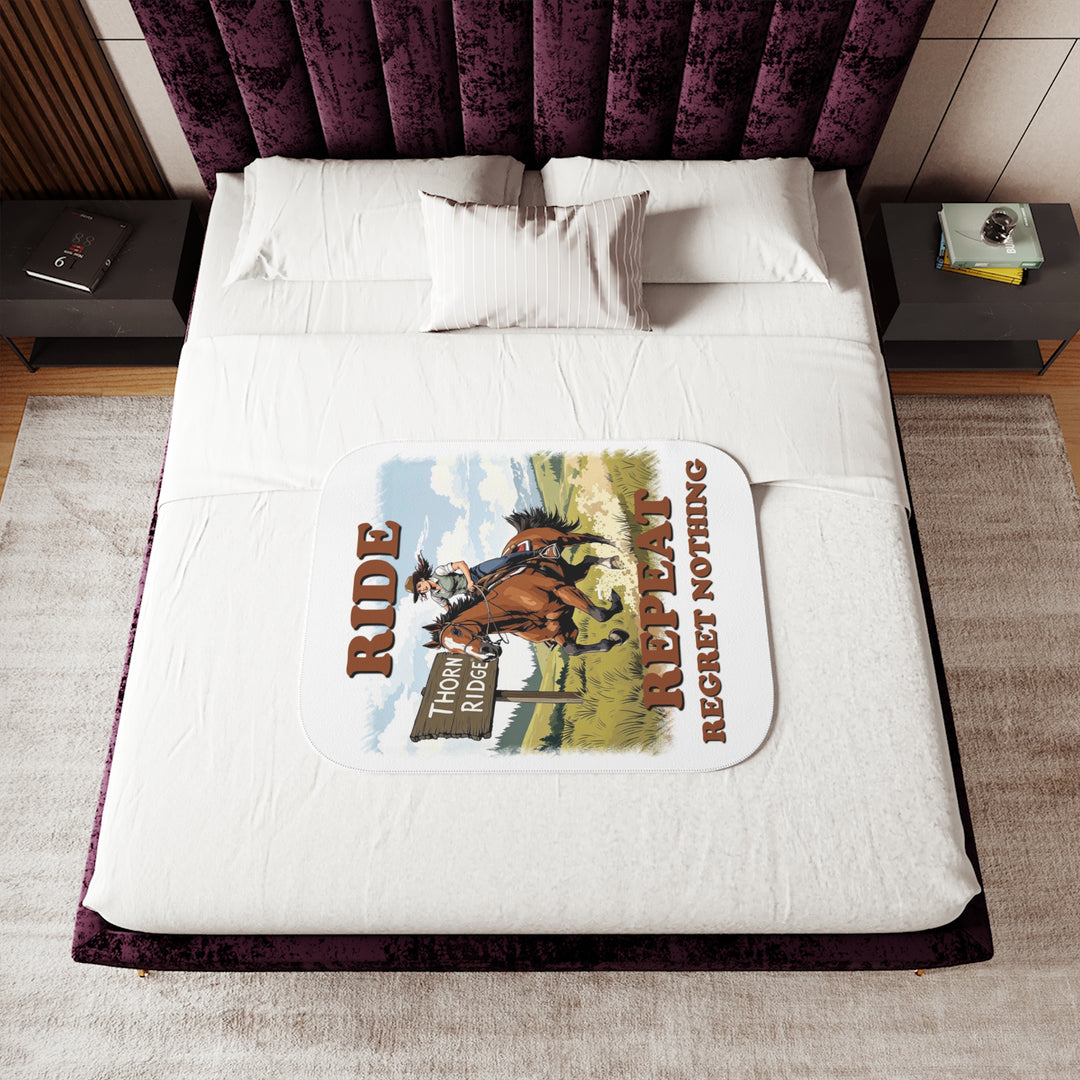 Decorative white sherpa blanket with a horse and rider graphic and text 'Ride Repeat Regret Nothing' and a sign that says the brand name Thorn Ridge®.
