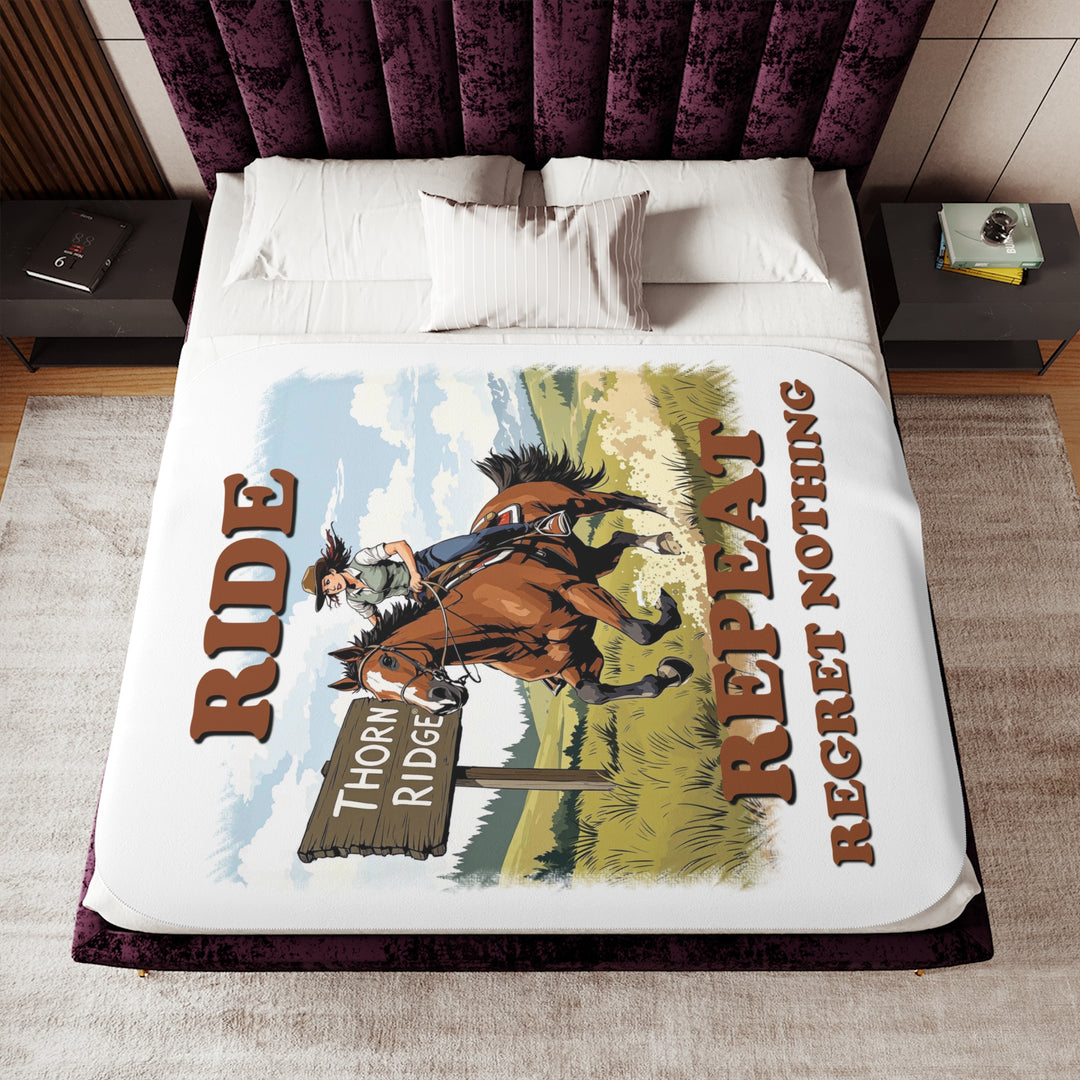 Decorative white sherpa blanket with a horse and rider graphic and text 'Ride Repeat Regret Nothing' and a sign that says the brand name Thorn Ridge®.