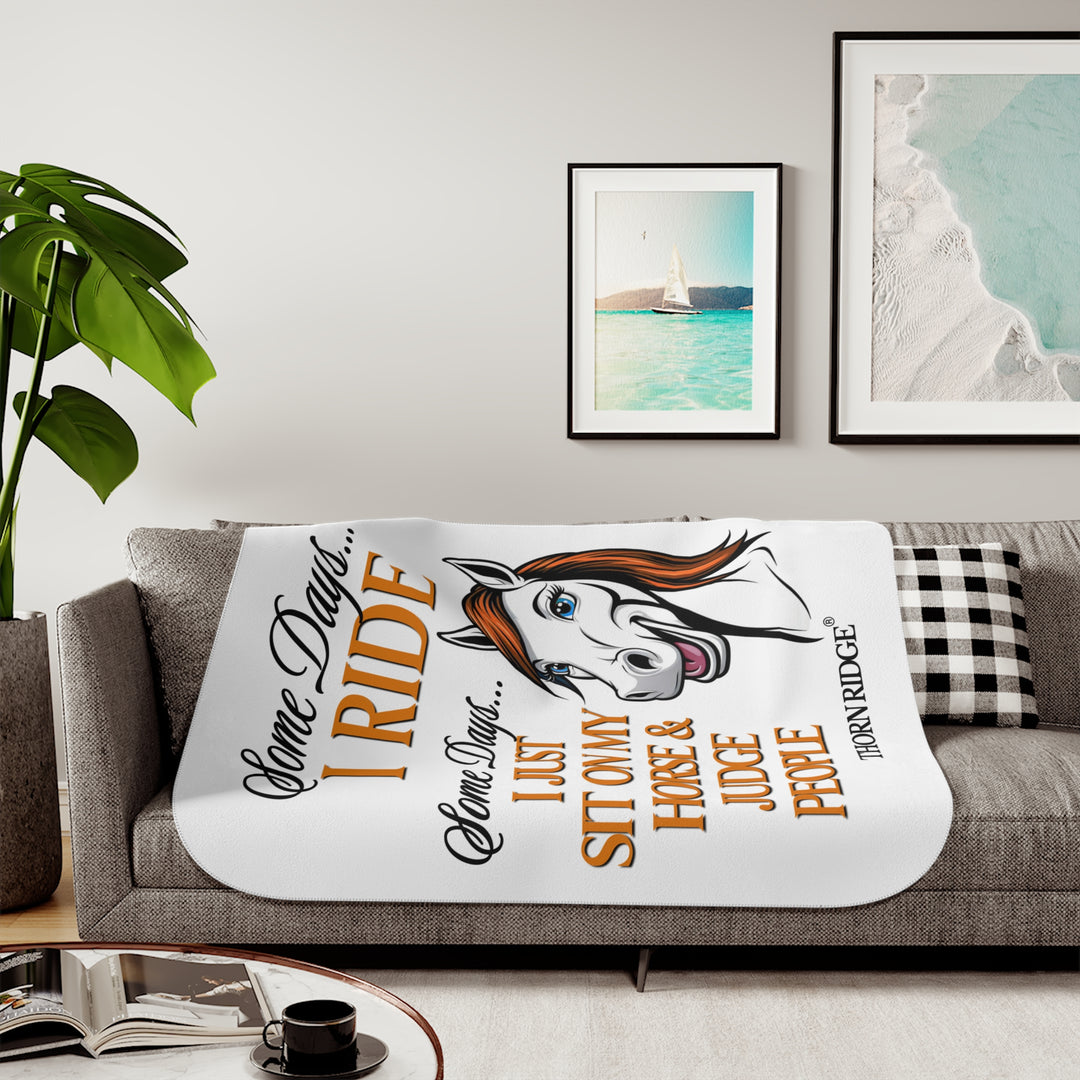 Some Days I ride Some days I just sit on my horse and judge people white sherpa blanket by Thorn Ridge® with  a white horse cartoon with a red mane and blue eyes.