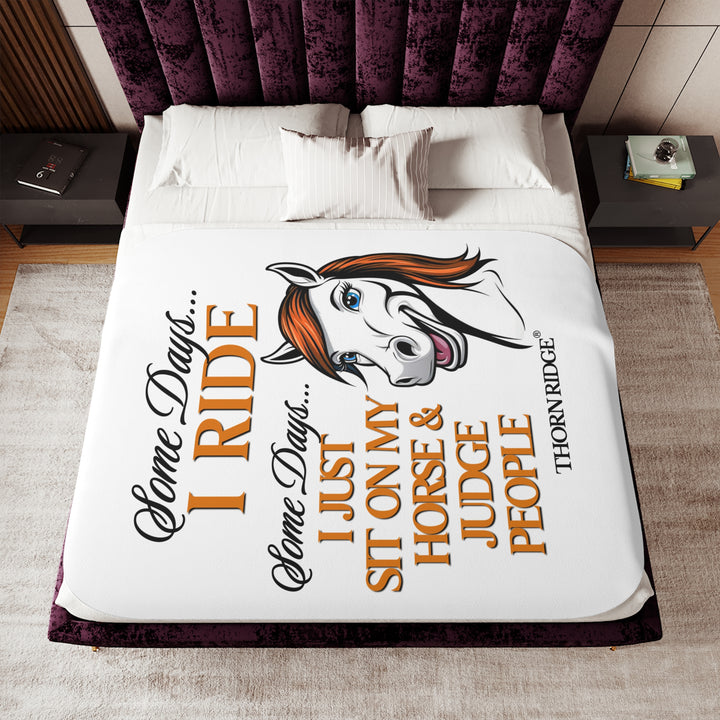 Some Days I ride Some days I just sit on my horse and judge people white sherpa blanket by Thorn Ridge® with  a white horse cartoon with a red mane and blue eyes.