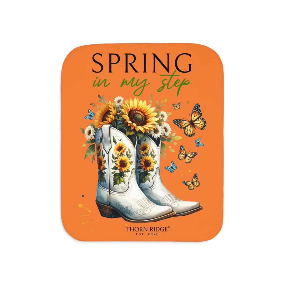 Spring in My Step Orange sherpa blanket with white cowgirl boots filled with sunflowers and sunflower decorations on the boots and butterflys around the boots by Thorn Ridge® Est 2020.