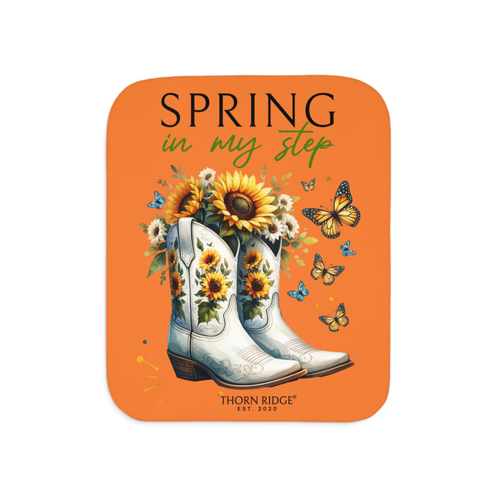 Spring in My Step Orange sherpa blanket with white cowgirl boots filled with sunflowers and sunflower decorations on the boots and butterflys around the boots by Thorn Ridge® Est 2020.