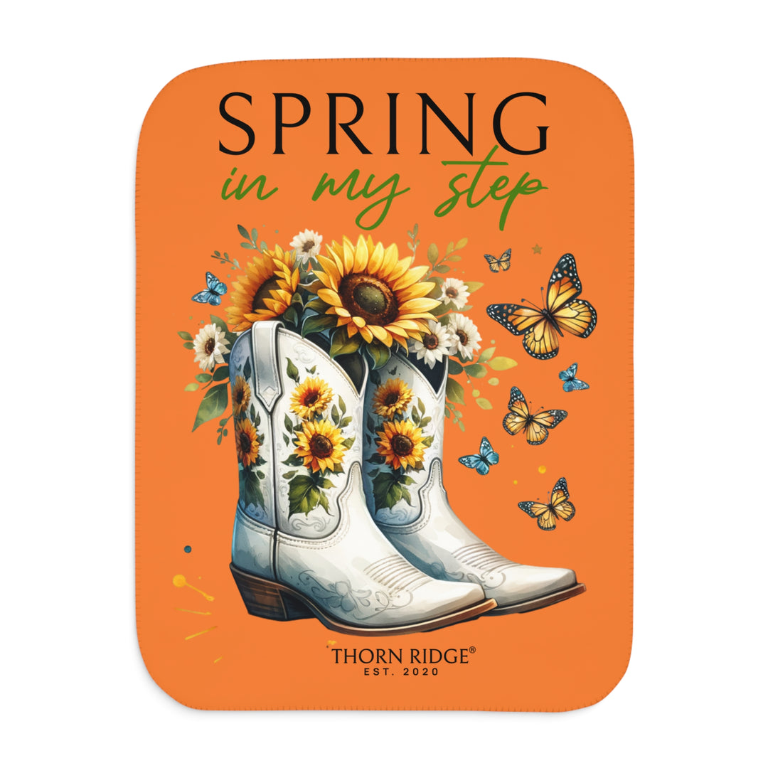 Spring in My Step Orange sherpa blanket with white cowgirl boots filled with sunflowers and sunflower decorations on the boots and butterflys around the boots by Thorn Ridge® Est 2020.