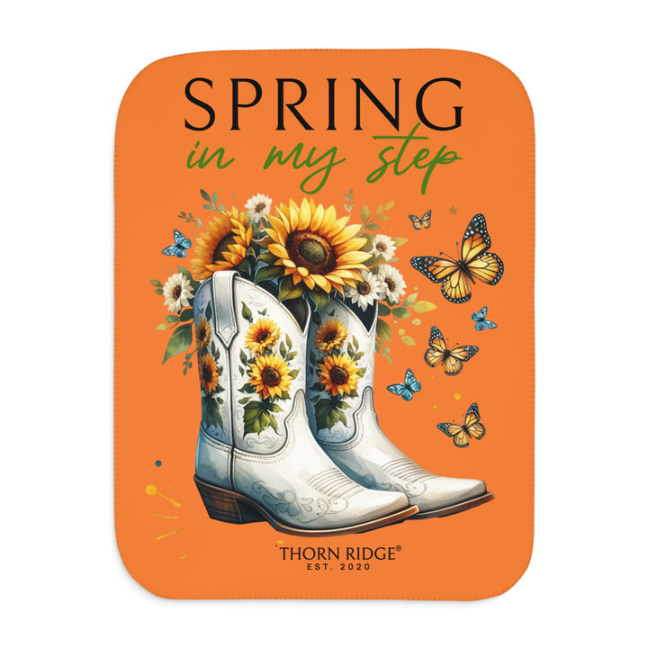 Spring in My Step Orange sherpa blanket with white cowgirl boots filled with sunflowers and sunflower decorations on the boots and butterflys around the boots by Thorn Ridge® Est 2020.