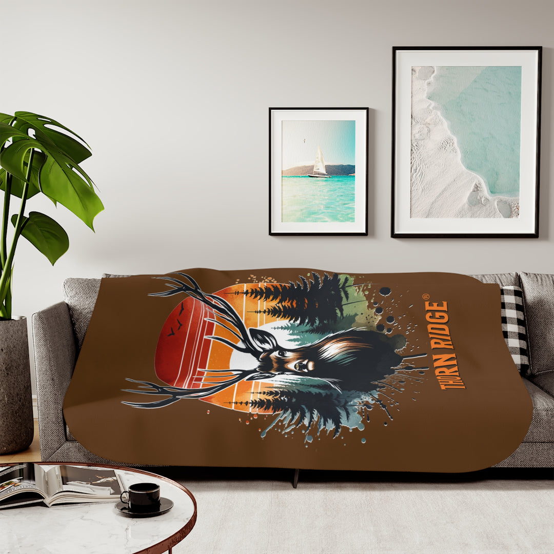 Guardian Buck at Sunset by Thorn Ridge® with an illustration of a buck facing the camera with a sunset in the background and forest trees.