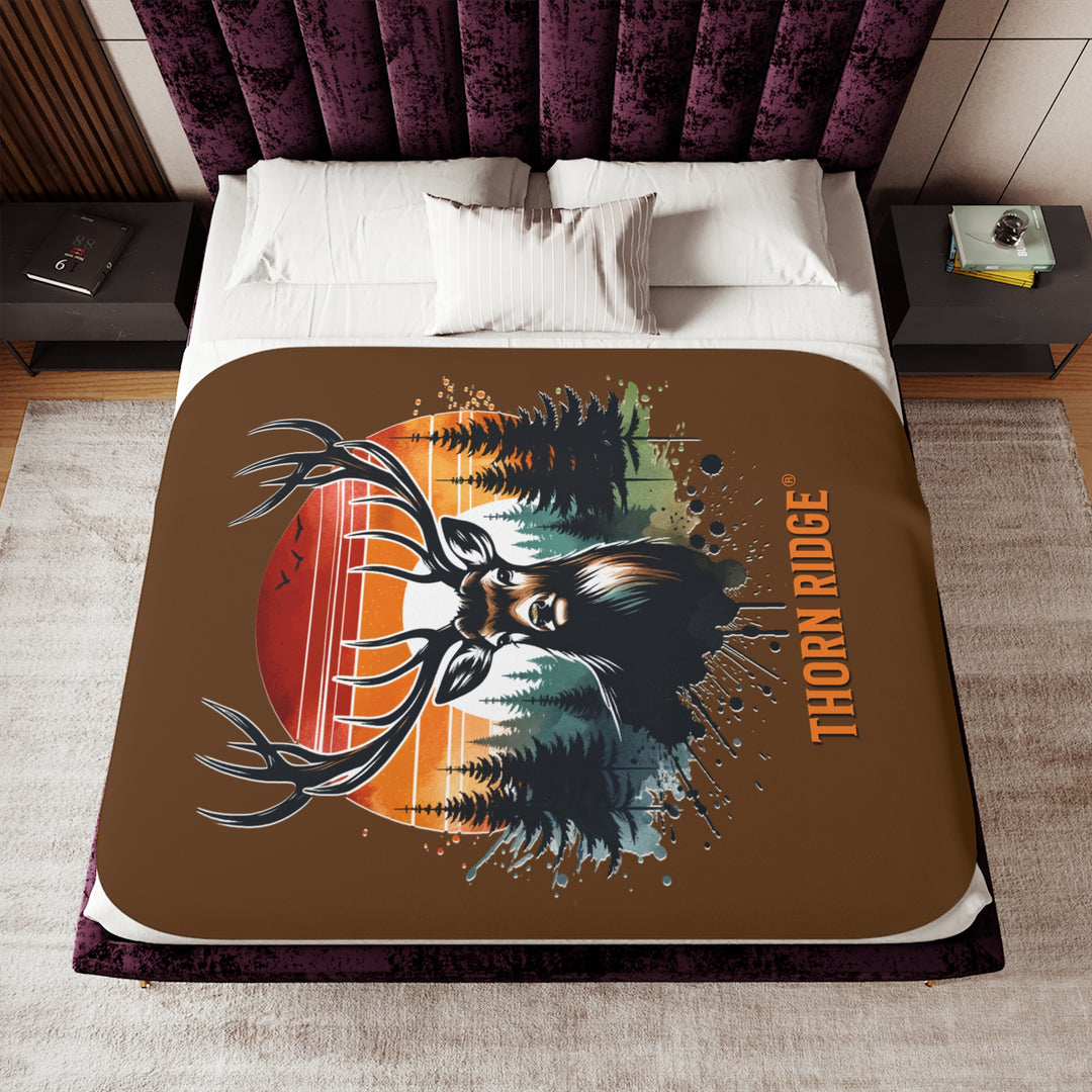 Guardian Buck at Sunset by Thorn Ridge® with an illustration of a buck facing the camera with a sunset in the background and forest trees.