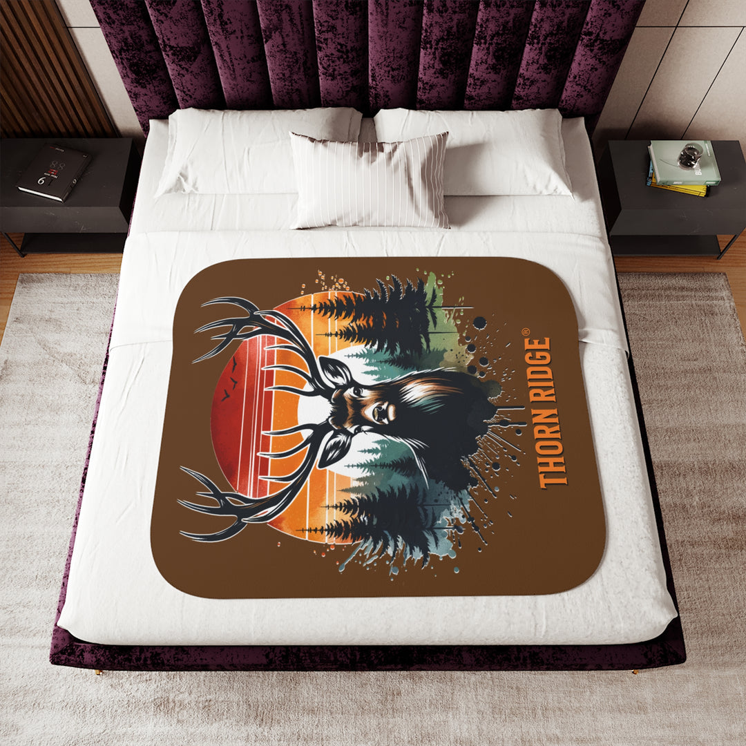 Guardian Buck at Sunset by Thorn Ridge® with an illustration of a buck facing the camera with a sunset in the background and forest trees.