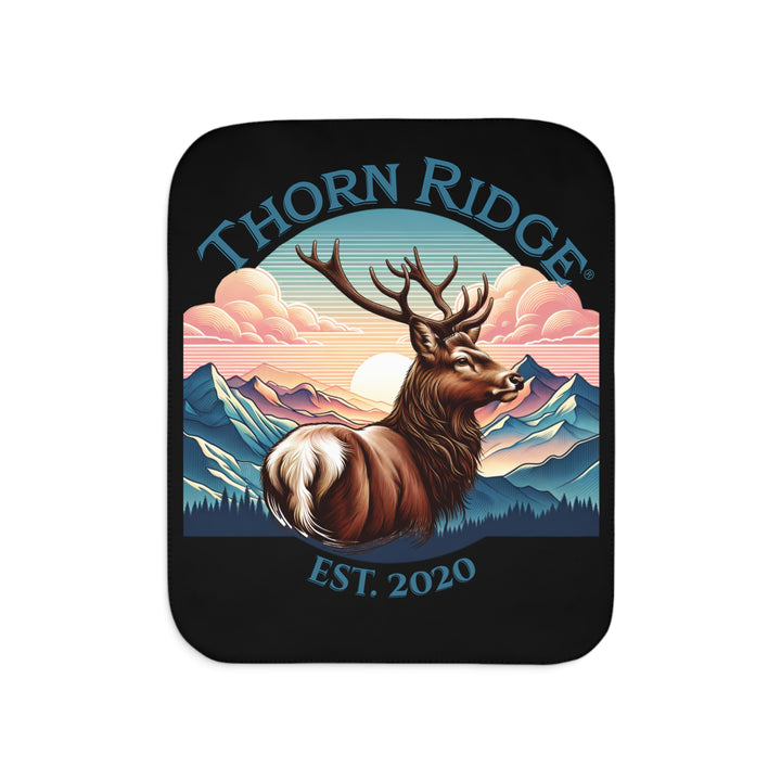 Black sherpa blanket with an illustration of a buck with antlers looking to the right with images of mountains in the background and the text Thorn Ridge® Est. 2020