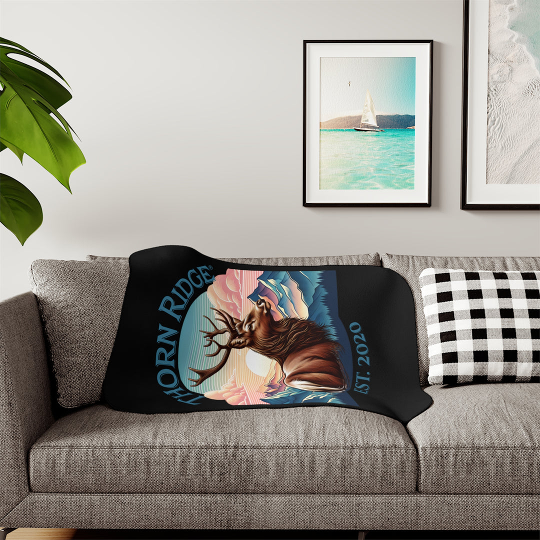 Black sherpa blanket with an illustration of a buck with antlers looking to the right with images of mountains in the background and the text Thorn Ridge® Est. 2020