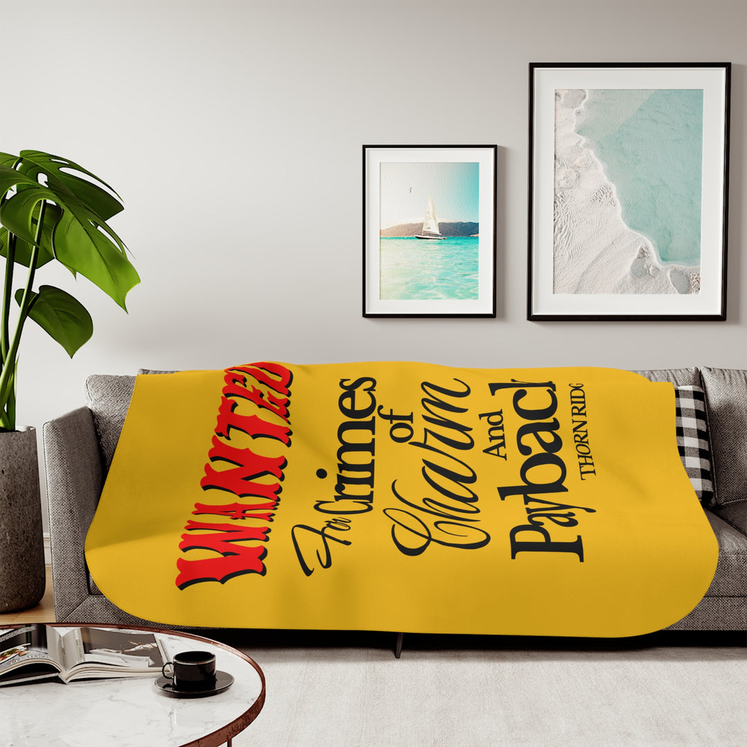 Yellow Sherpa Blanket with Wanted for crimes of charm and payback text branded Thorn Ridge® Wanted is in red text and the rest is in black text.