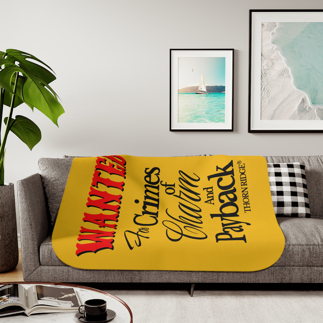 Yellow Sherpa Blanket with Wanted for crimes of charm and payback text branded Thorn Ridge® Wanted is in red text and the rest is in black text.