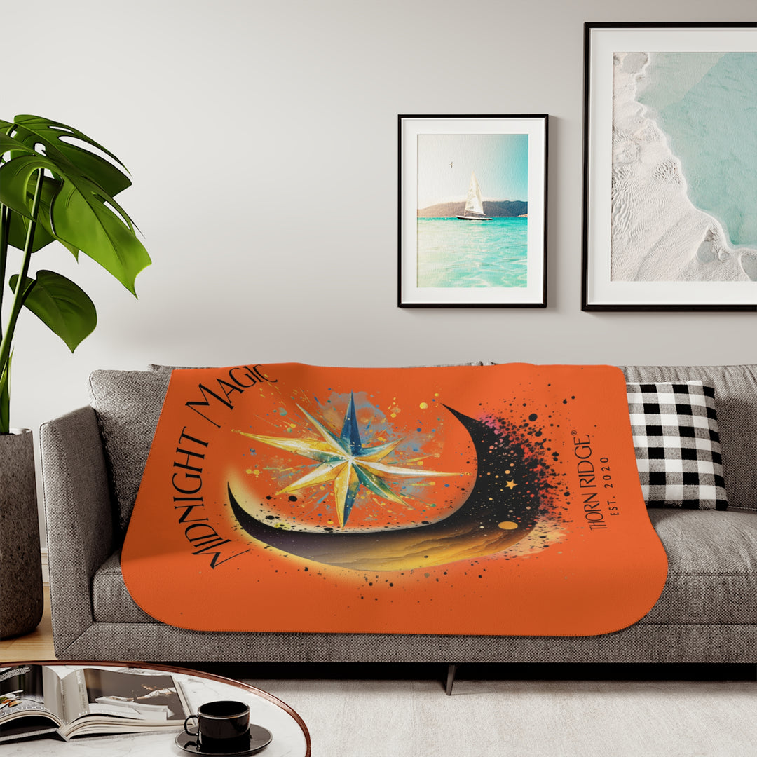 Midnight Magic orange sherpa blanket featuring a star and moon design and branded as Thorn Ridge® EST 2020