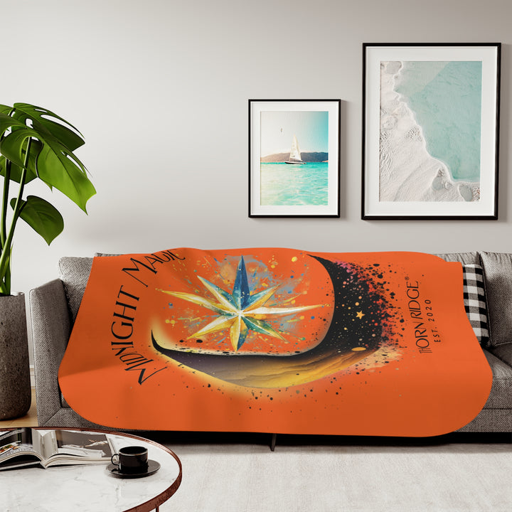 Midnight Magic orange sherpa blanket featuring a star and moon design and branded as Thorn Ridge® EST 2020