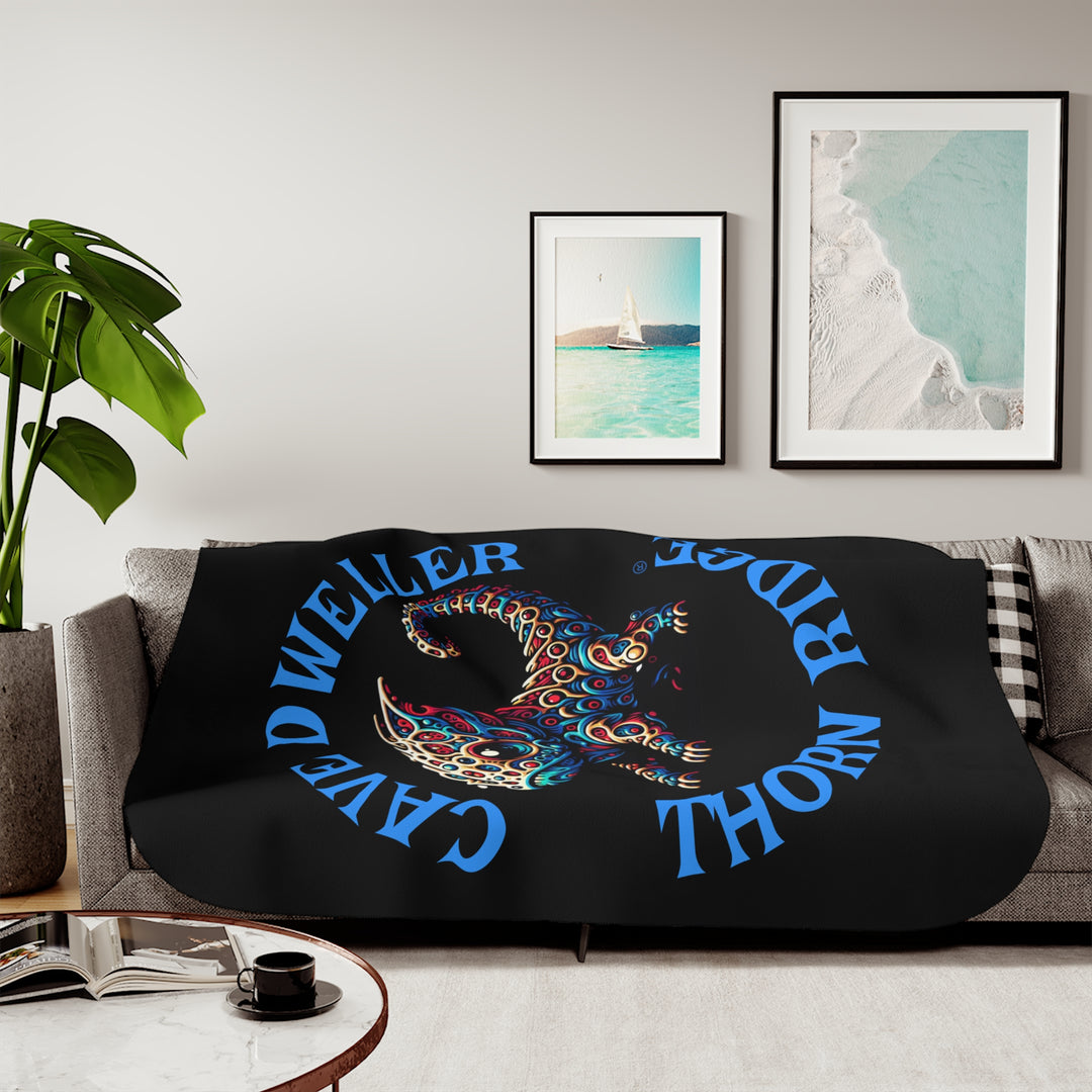 Cave Dweller by Thorn Ridge® black sherpa blanket featuring a weird lizard creature.