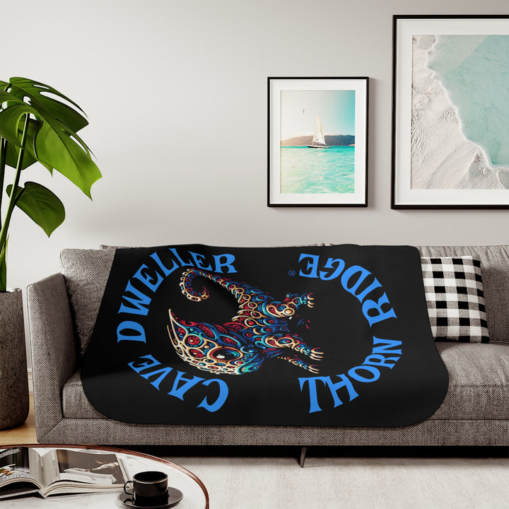 Cave Dweller by Thorn Ridge® black sherpa blanket featuring a weird lizard creature.