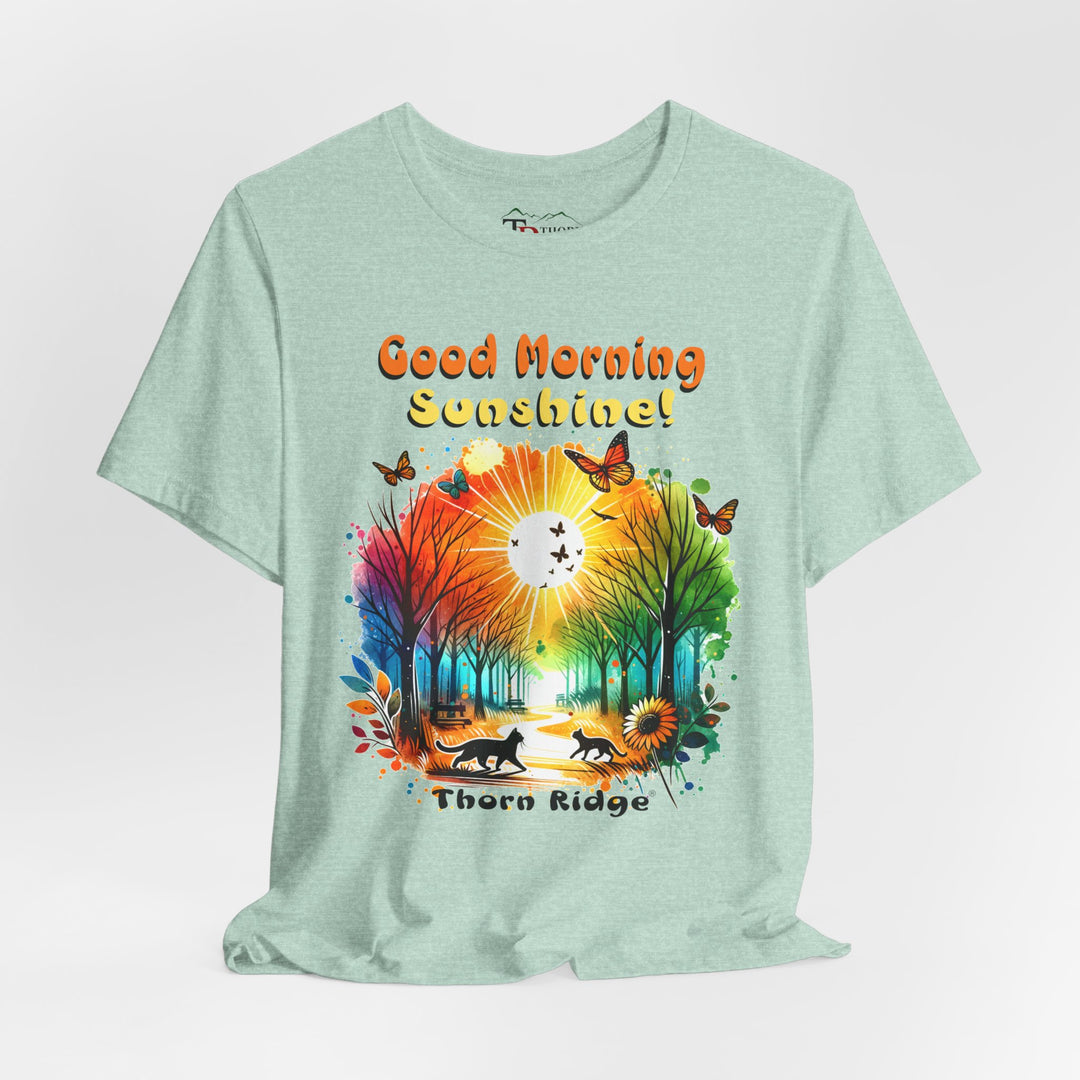 good morning sunshine graphic tee by Thorn Ridge featuring the sun shining through the trees and two cats walking across the path in a park.