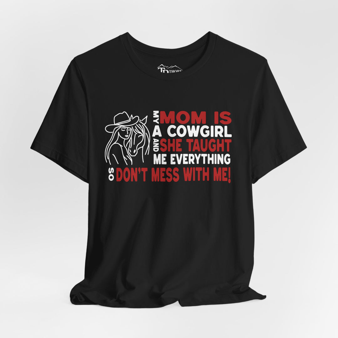 Mom is a cowgirl saying with neck label that says Thorn Ridge. Drawing of a girl and horse beside text. 