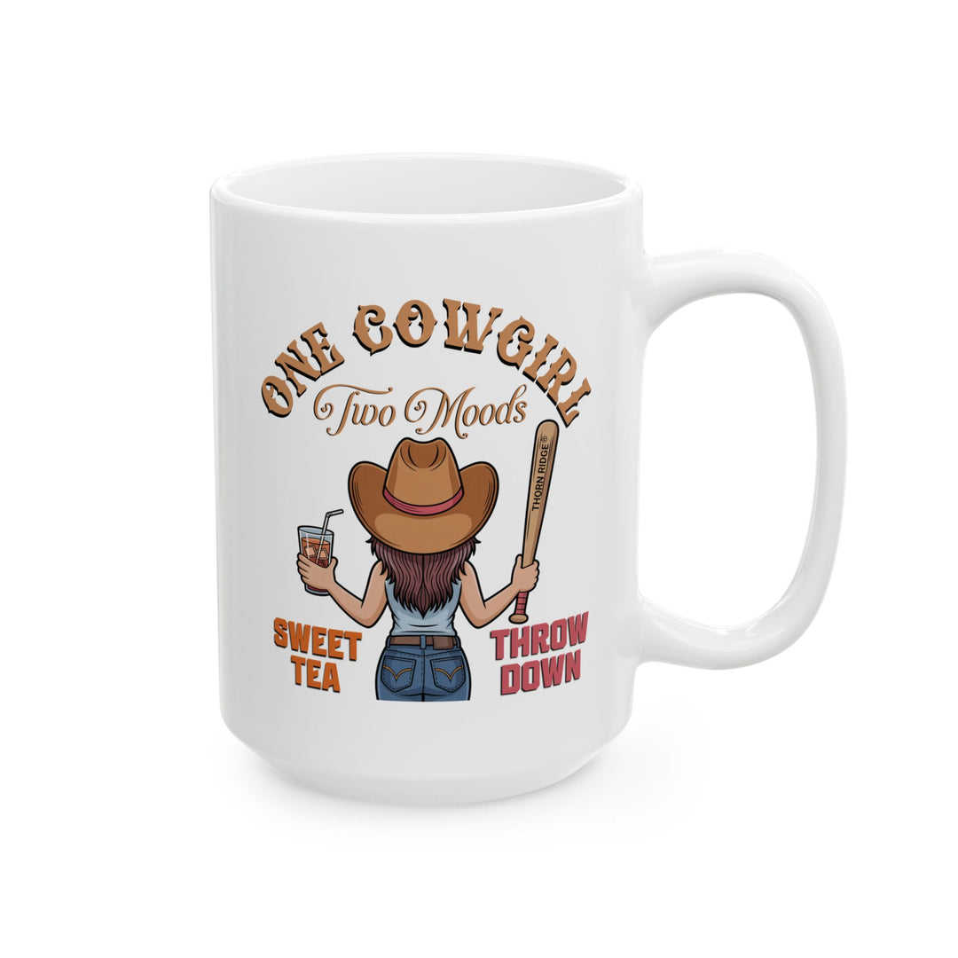 White mug by Thorn Ridge® with a graphic of a cowgirl holding a drink and a bat, with text 'One Cow Girl Two Moods Sweet Tea Throw Down' on a white background.