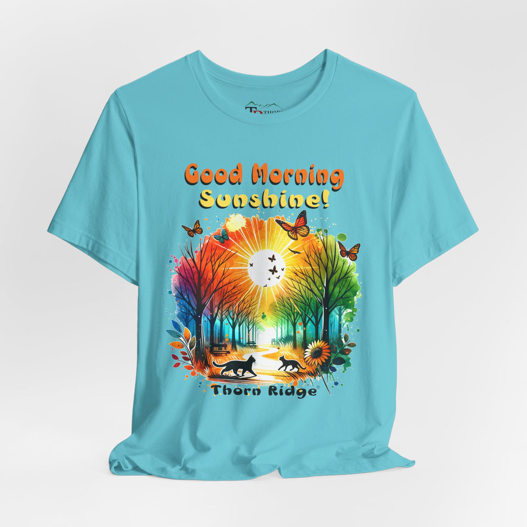 good morning sunshine graphic tee by Thorn Ridge featuring the sun shining through the trees and two cats walking across the path in a park.