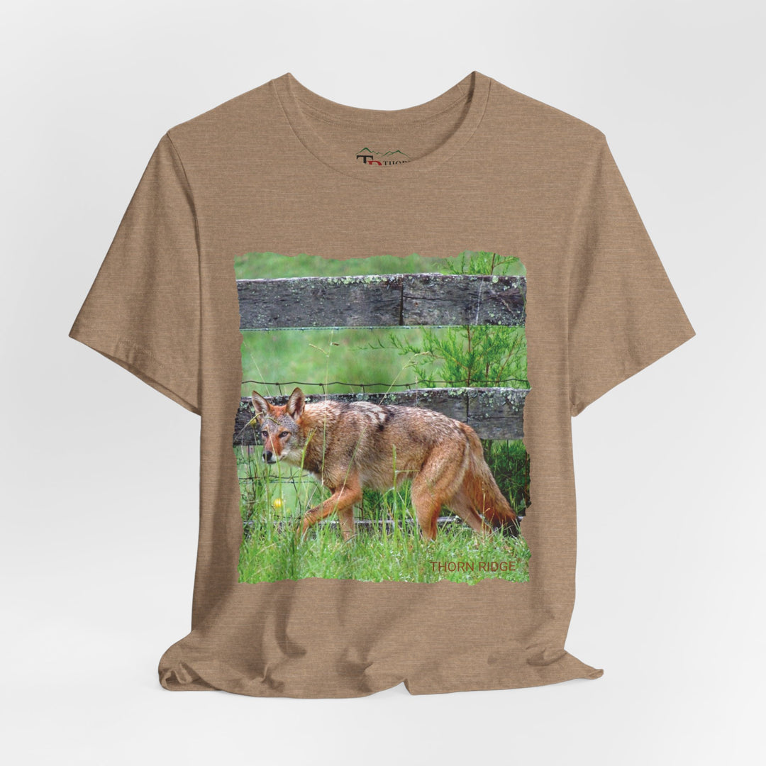 t-shirt with a photo of a red coyote against a weathered board fence and green grass labeled Thorn Ridge®