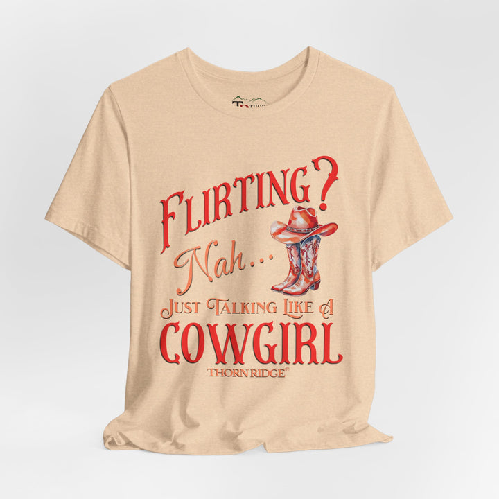 "Flirting? Nah... just talking like a cowgirl" graphic tee with women's cowgirl boots with a cowgirl hat sitting on top. Labeled Thorn Ridge®