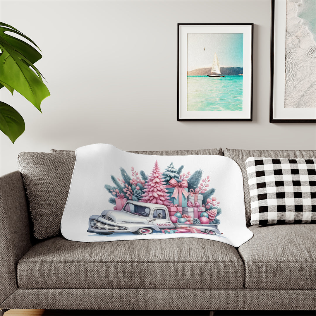 Vintage truck decorated with Christmas trees and presents on a white background with Thorn Ridge® branding on the door. Lying across a couch with a plant and pictures on the wall.