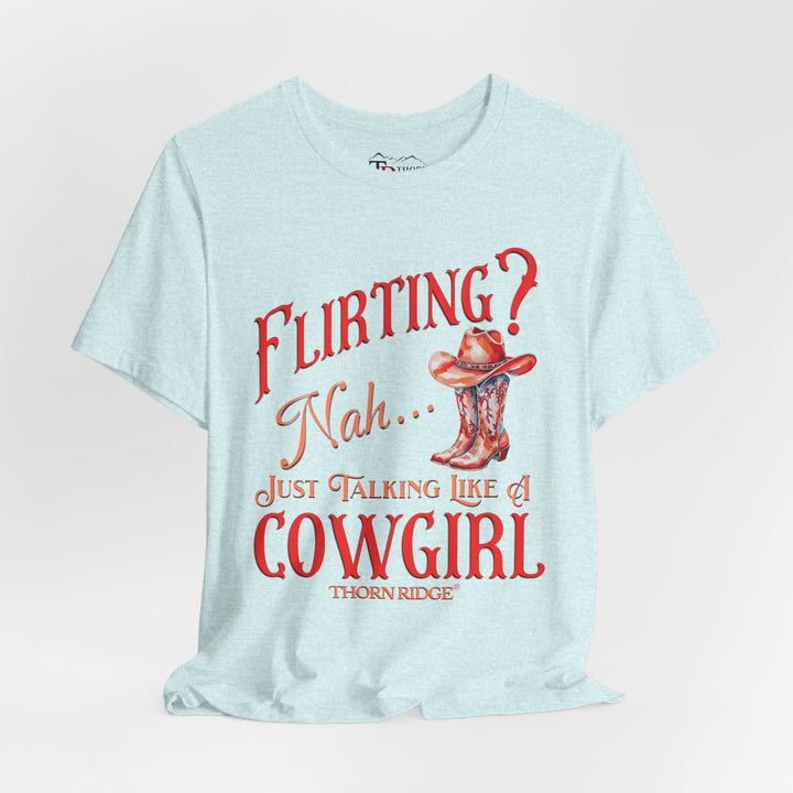 "Flirting? Nah... just talking like a cowgirl" graphic tee with women's cowgirl boots with a cowgirl hat sitting on top. Labeled Thorn Ridge®