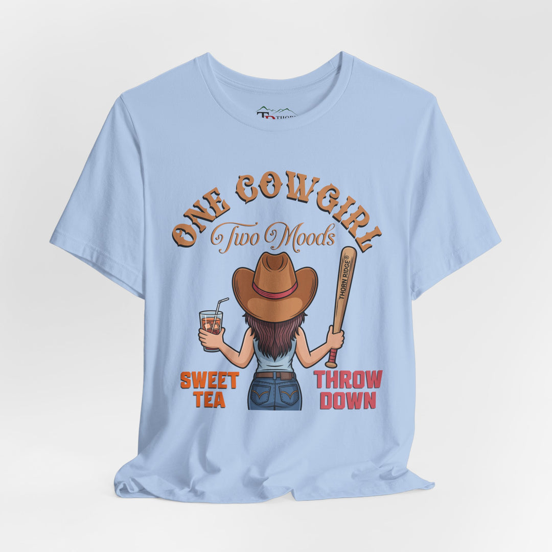 t-shirt with a graphic of a cowgirl holding a drink and a bat, with text 'One Cowgirl Two Moods Sweet Tea Throw Down' labeled Thorn Ridge®