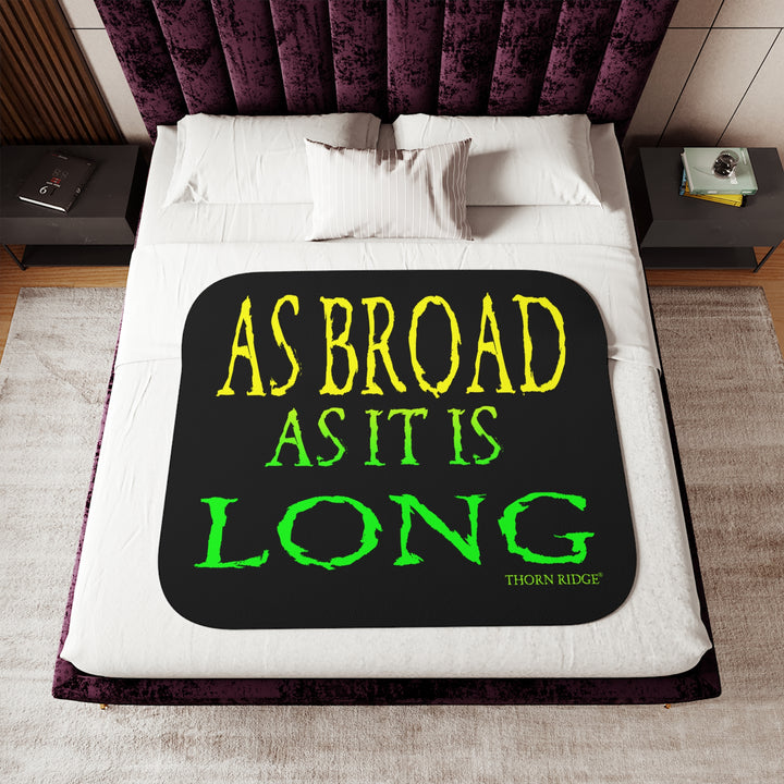 Black sherpa blanket with yellow and green text 'AS BROAD AS IT IS LONG' and 'THORN RIDGE' branding.
