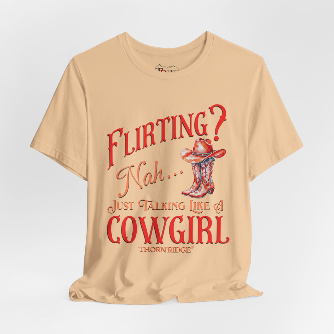 "Flirting? Nah... just talking like a cowgirl" graphic tee with women's cowgirl boots with a cowgirl hat sitting on top. Labeled Thorn Ridge®