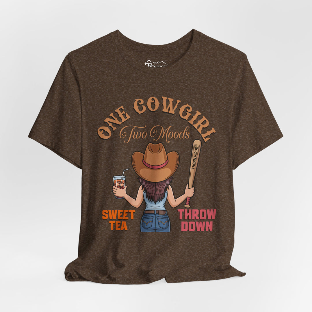 t-shirt with a graphic of a cowgirl holding a drink and a bat, with text 'One Cowgirl Two Moods Sweet Tea Throw Down' labeled Thorn Ridge®