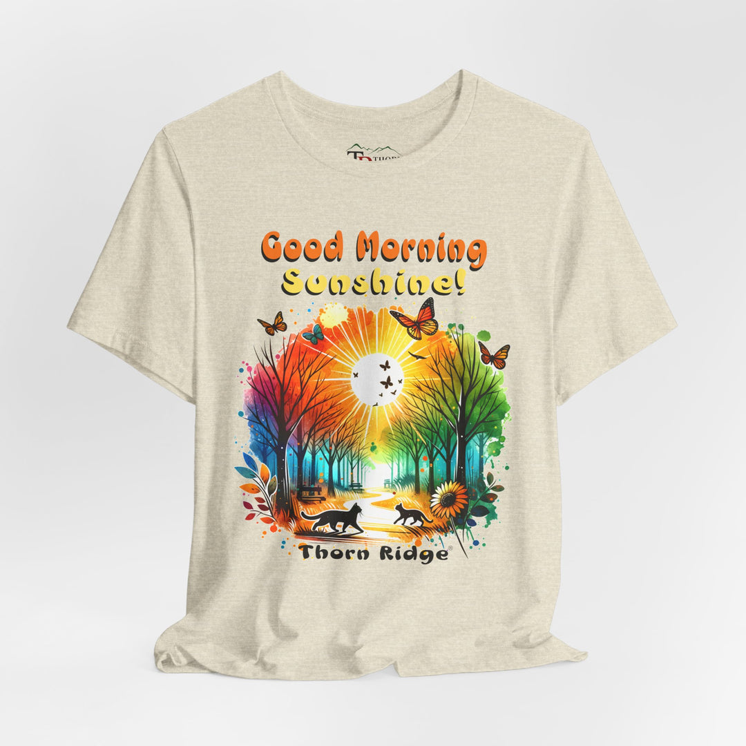 good morning sunshine graphic tee by Thorn Ridge featuring the sun shining through the trees and two cats walking across the path in a park.
