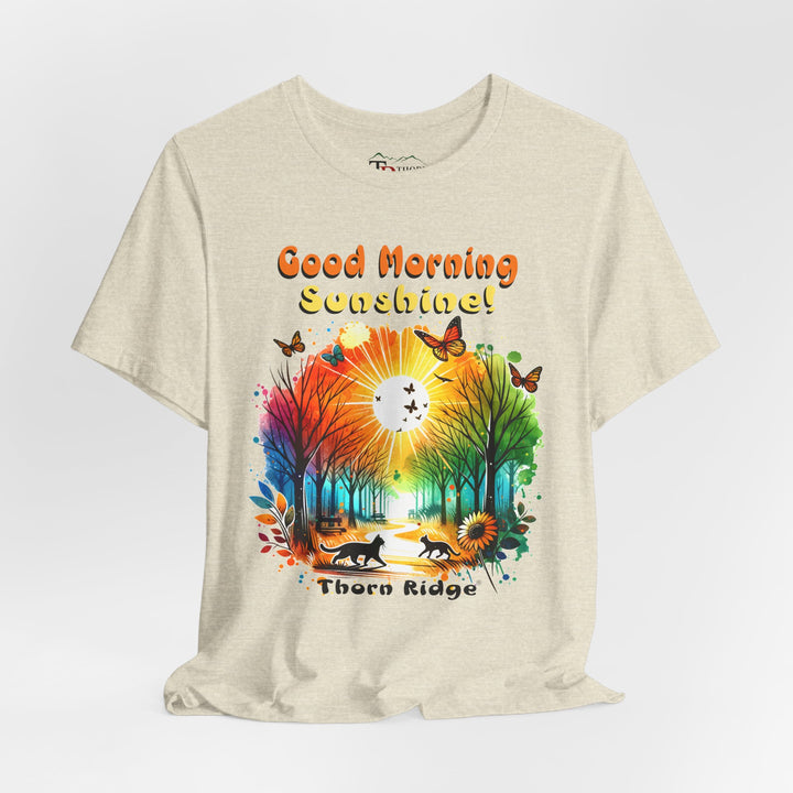 good morning sunshine graphic tee by Thorn Ridge featuring the sun shining through the trees and two cats walking across the path in a park.