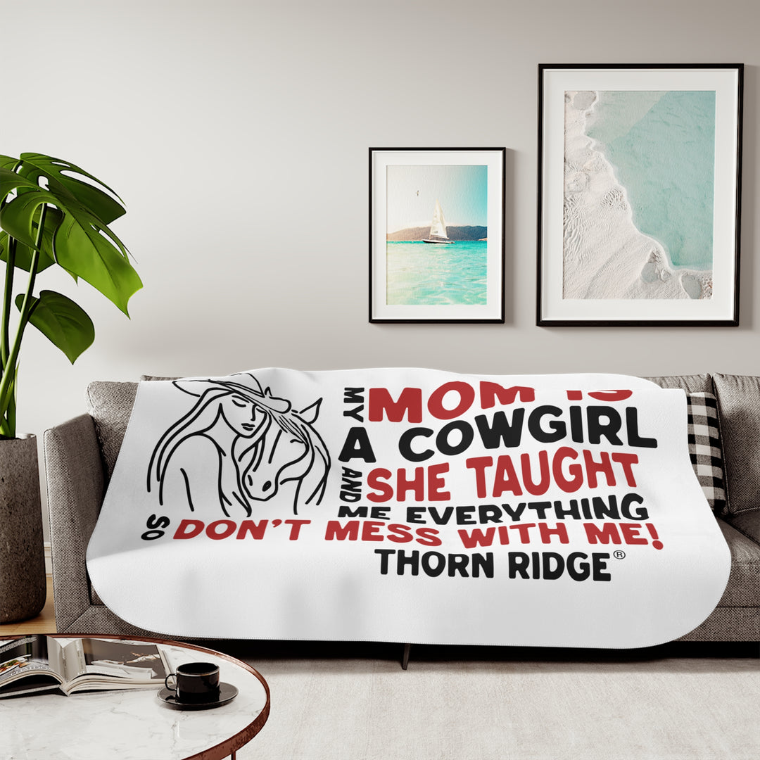 Mom Is A Cowgirl and she taught me everything so don't mess with me slogan graphic with a outline drawing of a woman with a cowboy hat hugging a horse by Thorn Ridge®