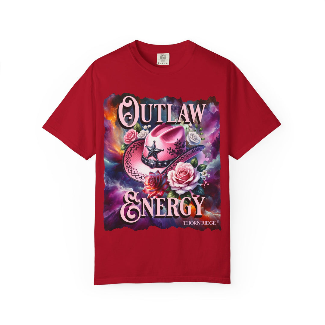 Outlaw Energy graphic tee with a pink cowgirl hat and roses on a celestial background of pinks, blues, and oranges. Labeled Thorn Ridge®