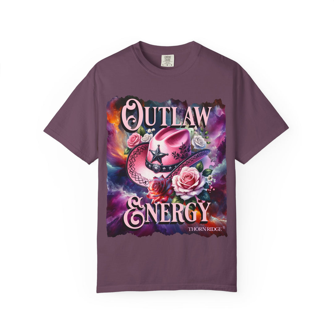 Outlaw Energy graphic tee with a pink cowgirl hat and roses on a celestial background of pinks, blues, and oranges. Labeled Thorn Ridge®