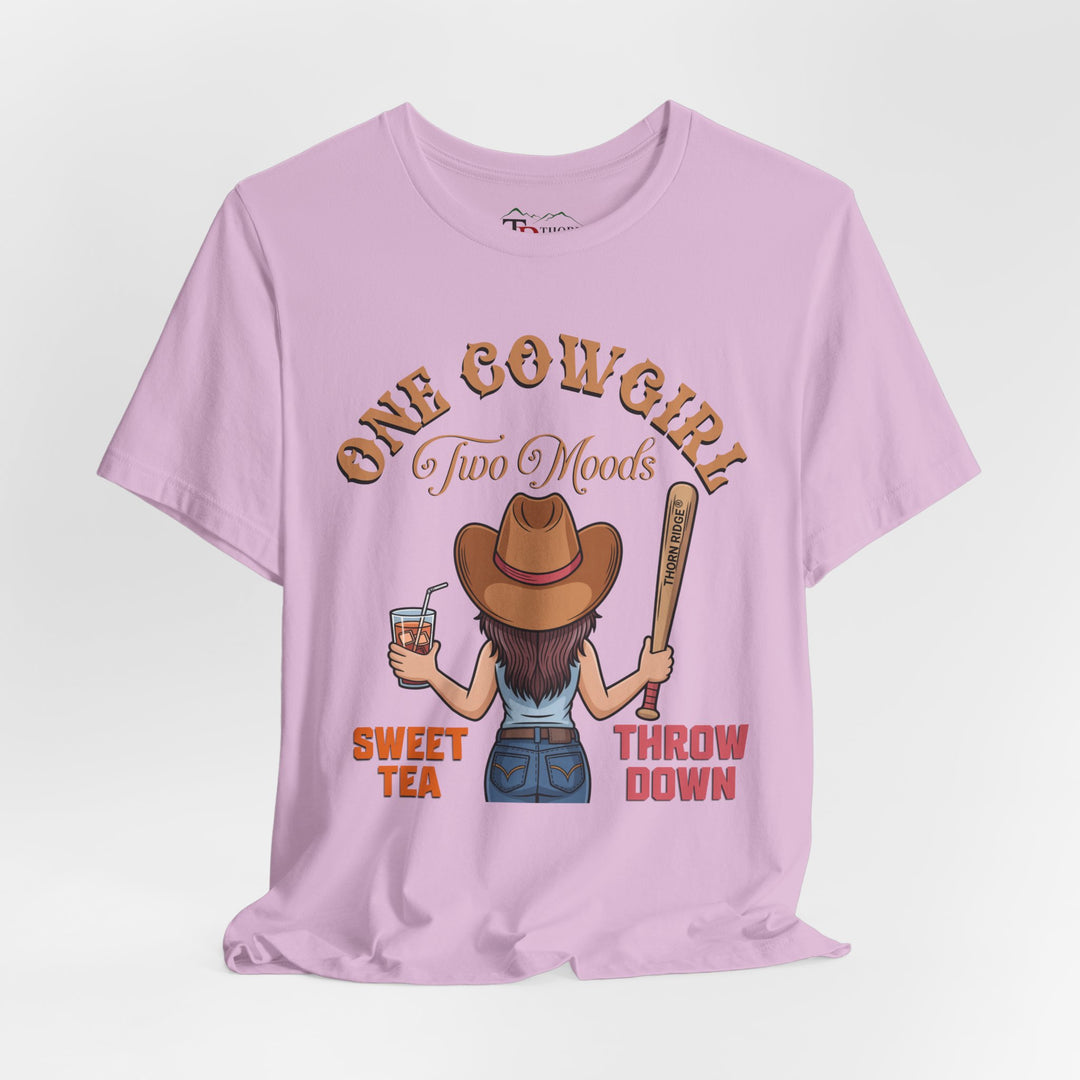 t-shirt with a graphic of a cowgirl holding a drink and a bat, with text 'One Cowgirl Two Moods Sweet Tea Throw Down' labeled Thorn Ridge®