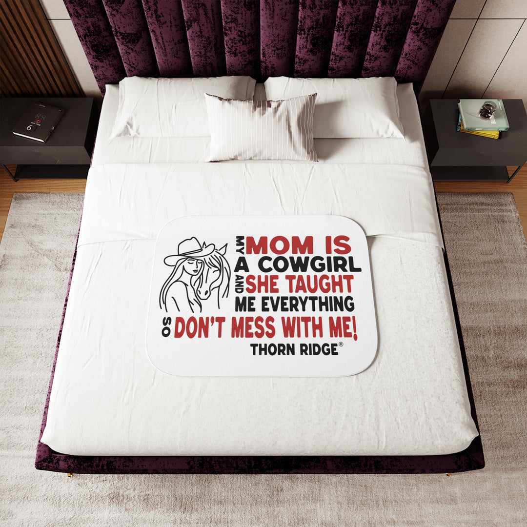 Mom Is A Cowgirl and she taught me everything so don't mess with me slogan graphic with a outline drawing of a woman with a cowboy hat hugging a horse by Thorn Ridge®