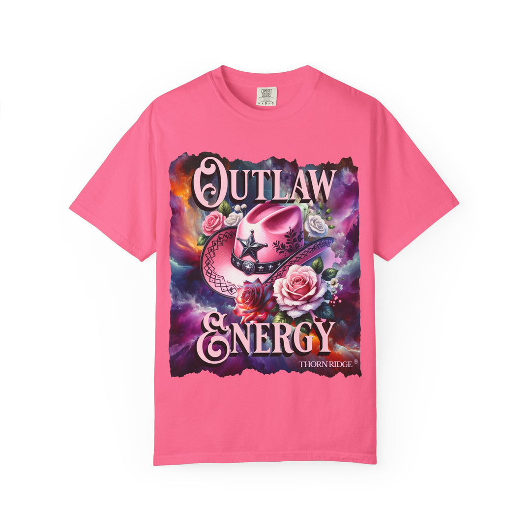 Outlaw Energy graphic tee with a pink cowgirl hat and roses on a celestial background of pinks, blues, and oranges. Labeled Thorn Ridge®